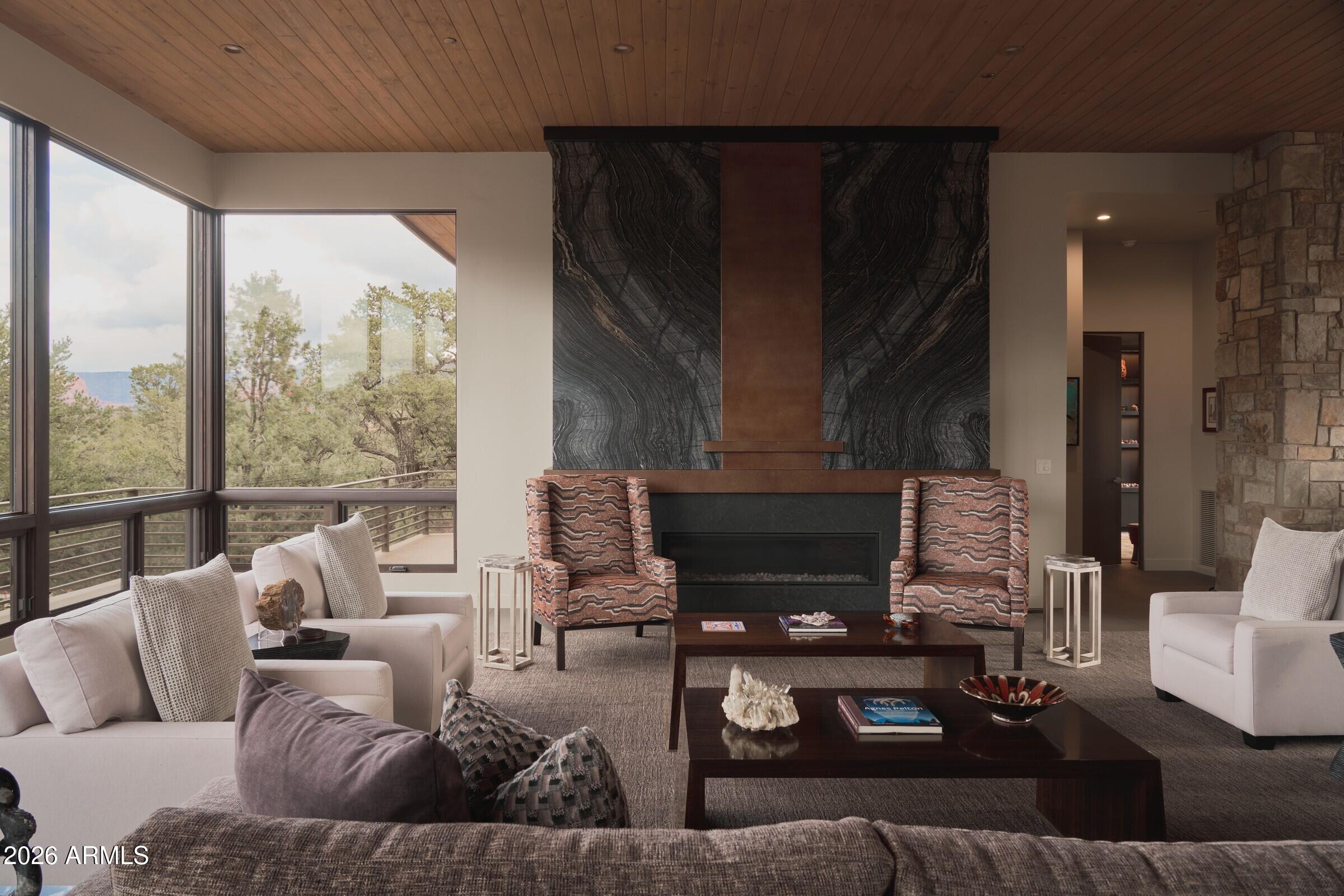2925 Red Hawk Lane Sedona, AZ 86336 - Photo 6 of 35 a living room with furniture and a floor to ceiling window