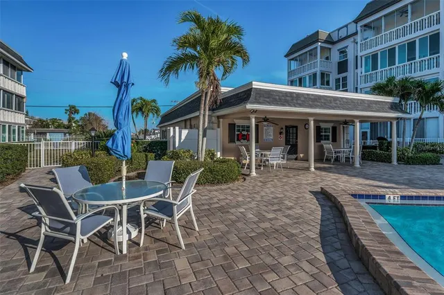 a view of a house with backyard porch and sitting area