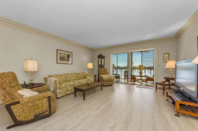 a living room with furniture flat screen tv and a window