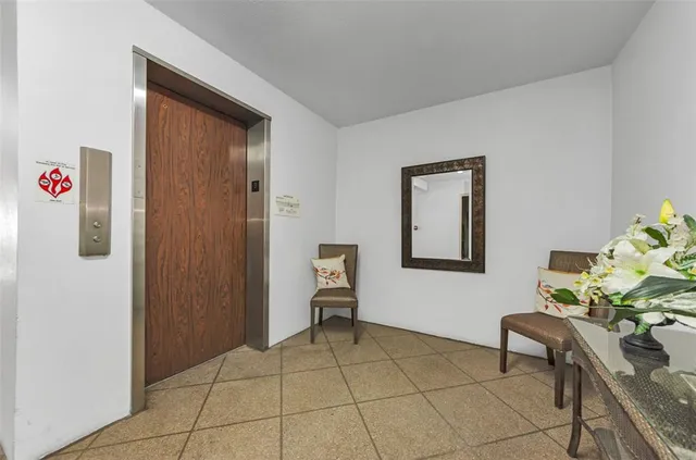 a view of an entryway with table and chair