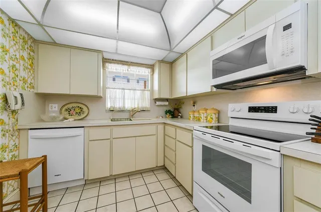 a kitchen with cabinets stainless steel appliances and counter space