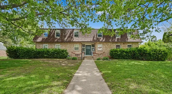 a front view of a house next to a yard