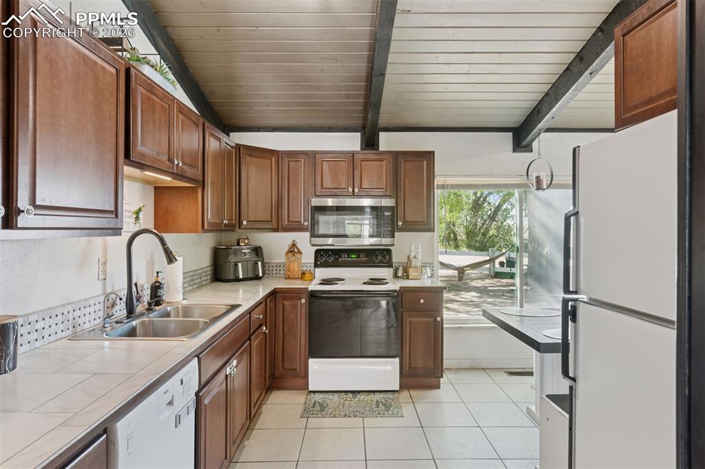 16880-1688 Old Pueblo Road Fountain, CO 80817 - Photo 26 of 47 Kitchen featuring ample cabinetry, full appliance package with direct access to outdoor space