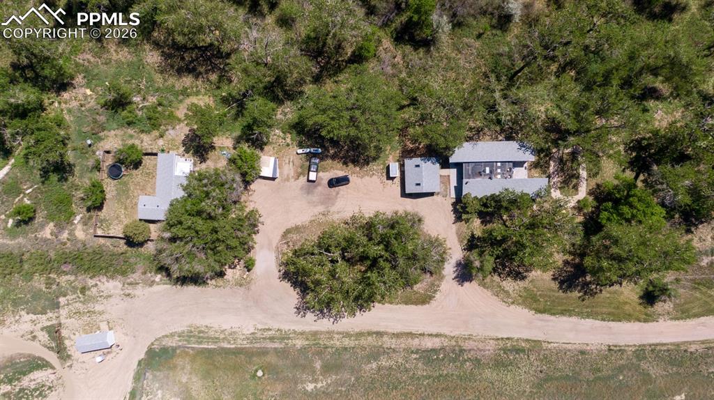 16880-1688 Old Pueblo Road Fountain, CO 80817 - Photo 4 of 47 Overhead view of the two existing single-family residences nestled within mature trees, showing internal access, separation, and flexibility for on-site use or management.