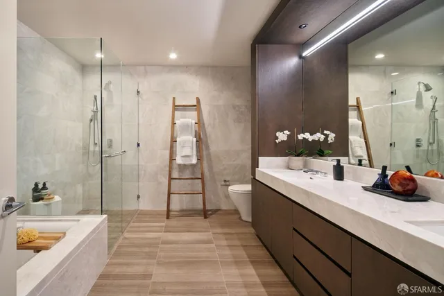 a bathroom with a double vanity sink a large mirror and shower