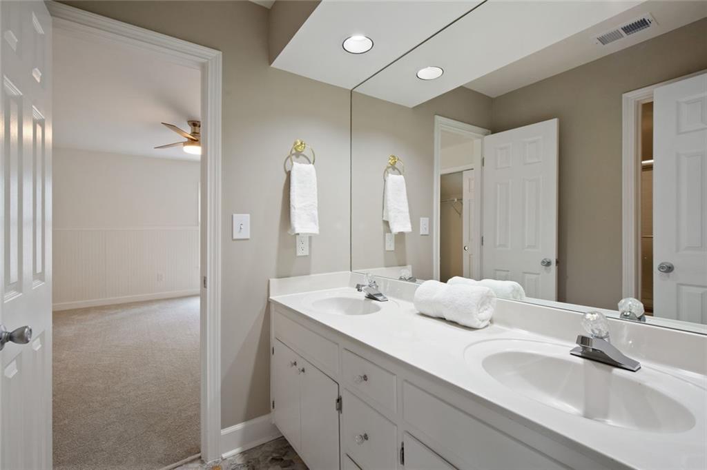 715 Winterwind Way Roswell, GA 30075 - Photo 32 of 83 a bathroom with double vanity sinks and a mirror