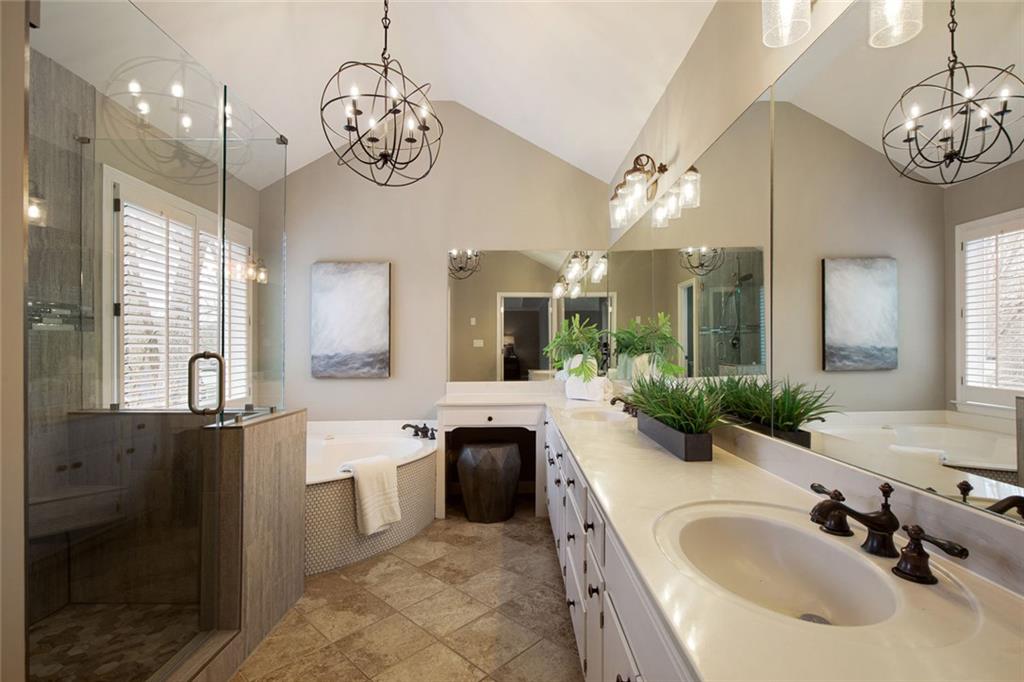 715 Winterwind Way Roswell, GA 30075 - Photo 36 of 83 a spacious bathroom with a granite countertop sink a large mirror and a shower