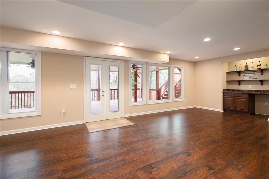 715 Winterwind Way Roswell, GA 30075 - Photo 40 of 83 an empty room with wooden floor and windows