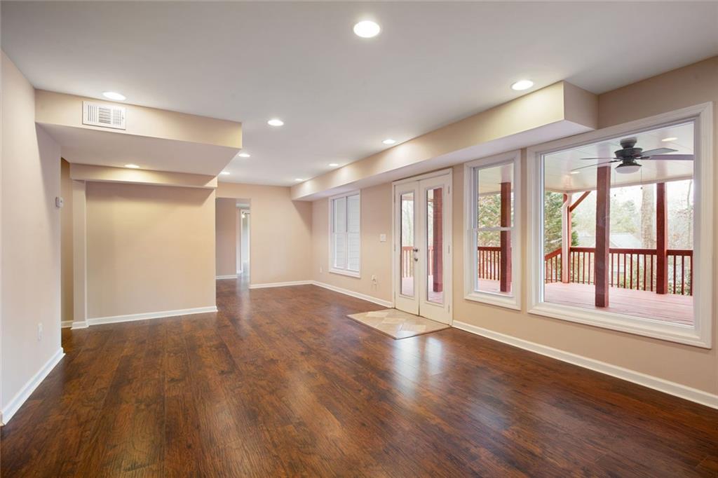 715 Winterwind Way Roswell, GA 30075 - Photo 45 of 83 a view of an empty room with a window and wooden floor