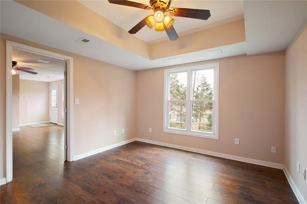 715 Winterwind Way Roswell, GA 30075 - Photo 46 of 83 a view of an empty room with window and wooden floor