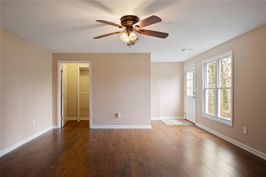 715 Winterwind Way Roswell, GA 30075 - Photo 47 of 83 a view of an empty room with window and wooden floor