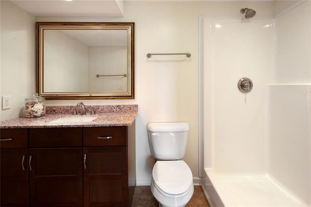 715 Winterwind Way Roswell, GA 30075 - Photo 48 of 83 a bathroom with a granite countertop toilet sink and mirror