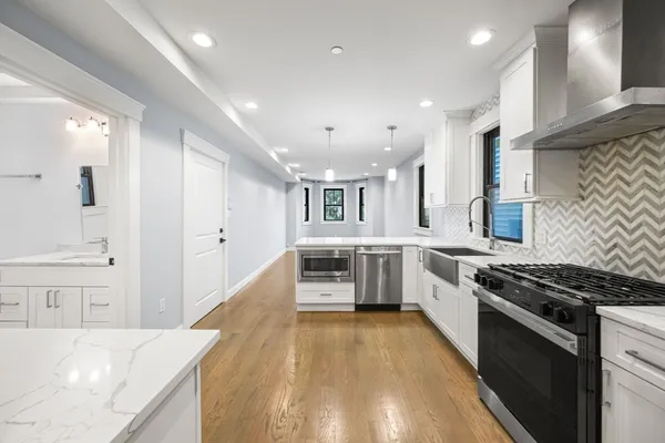a kitchen with stainless steel appliances granite countertop a stove and a sink