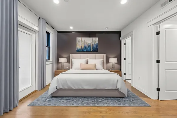 a spacious bedroom with a bed and a window