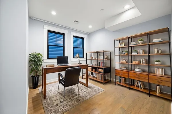 a workspace with furniture window and wooden floor