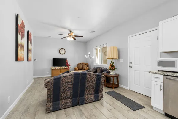 a living room with furniture kitchen and a window