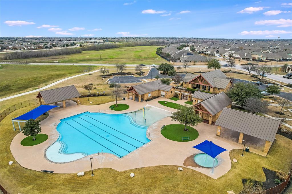 19620 Stanton Drew Pflugerville, TX 78660 - Photo 30 of 33 Community pool with a patio area and a residential view