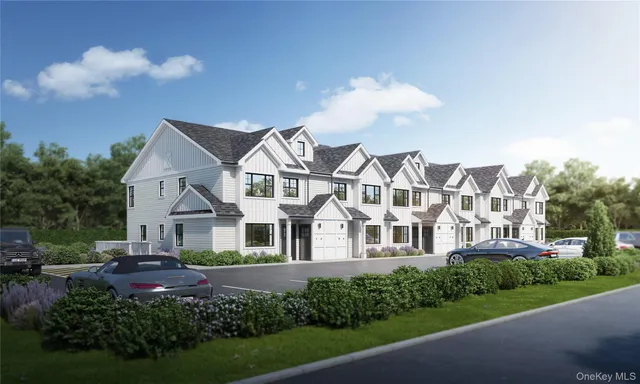 a view of a white house next to a yard