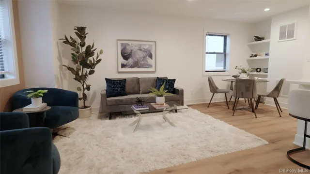a living room with furniture and a potted plant