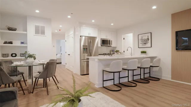 a kitchen with stainless steel appliances kitchen island granite countertop a sink and cabinets