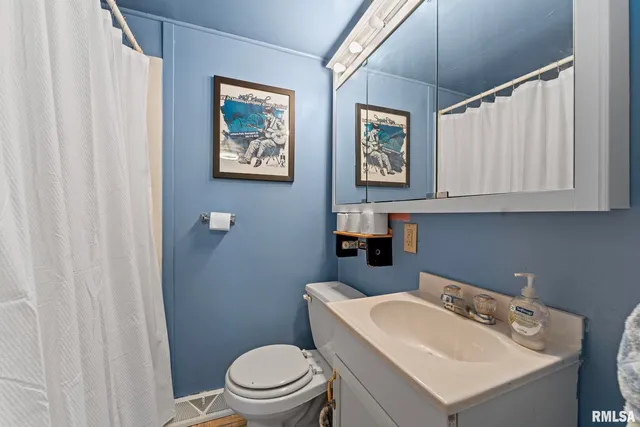 a bathroom with a toilet a sink and a mirror