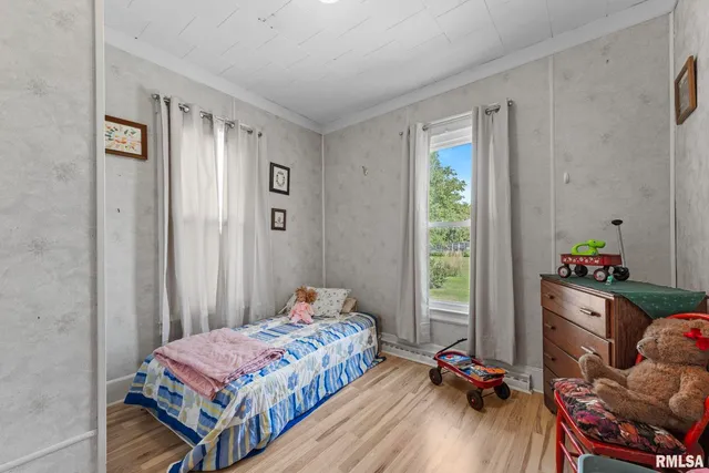 a bedroom with a bed and a window