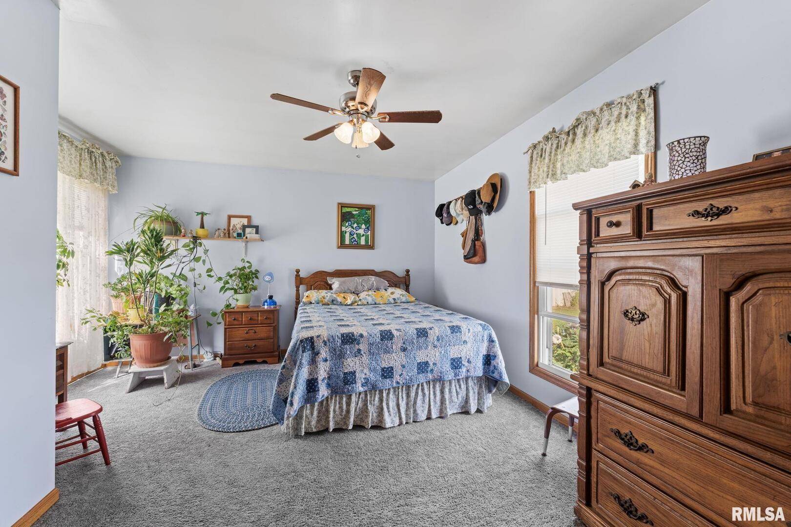 607 Northwest 8th Avenue Aledo, IL 61231 - Photo 10 of 22 a bedroom with bed and a chandelier