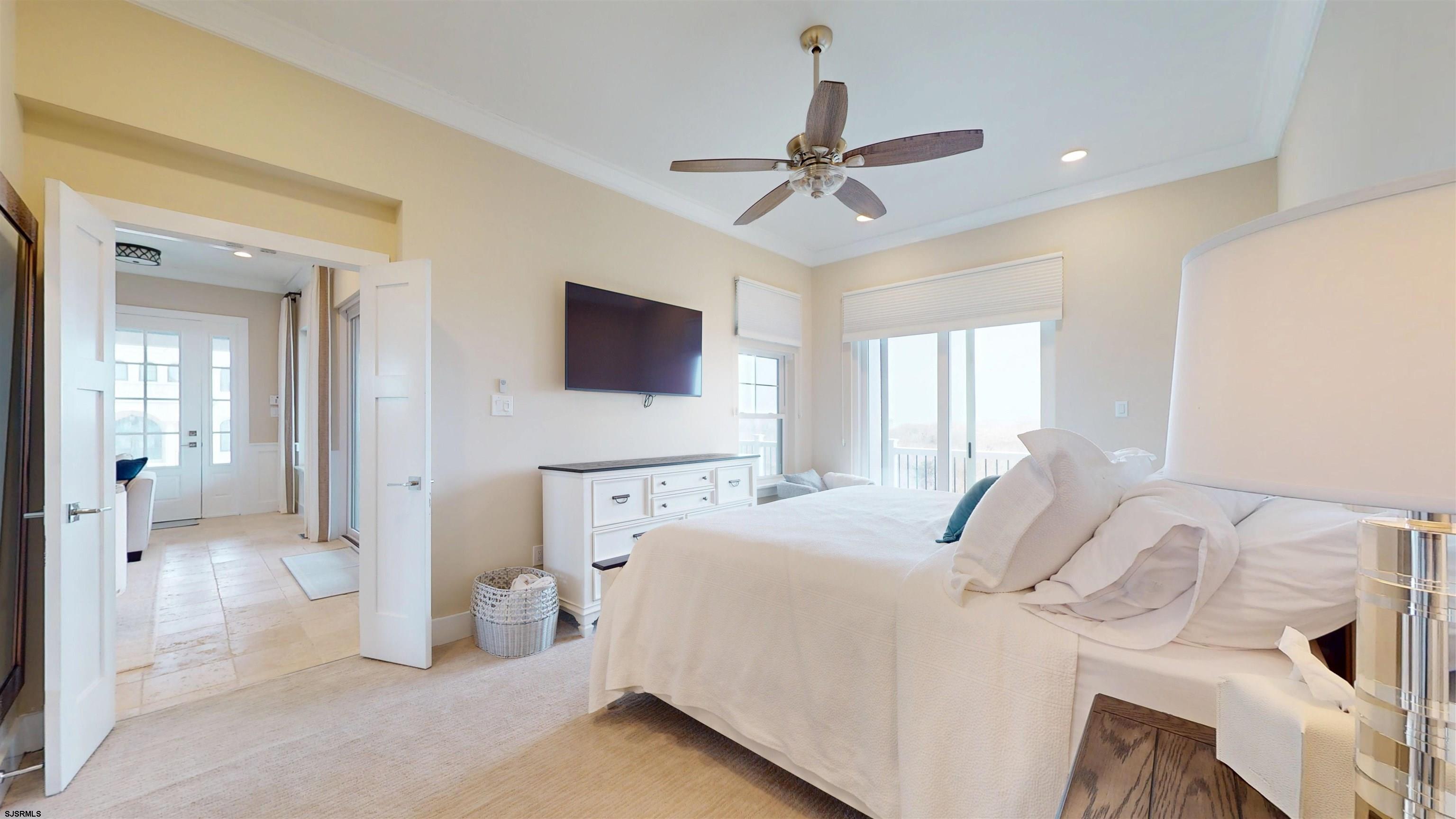 404 21st Street South Brigantine, NJ 08203 - Photo 30 of 92 a bedroom with a bed and a flat screen tv