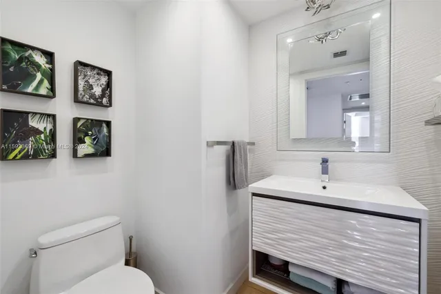 a bathroom with a sink toilet mirror and shower