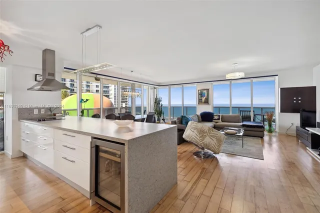 a kitchen with kitchen island granite countertop a sink table and chairs