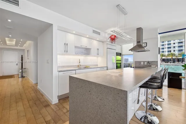 a kitchen with kitchen island a stove and a refrigerator