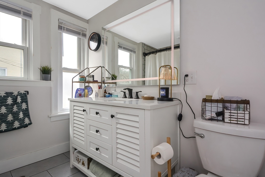 21 Cemetery Street, Unit 21 Hopedale, MA 01747 - Photo 13 of 19 a bathroom with a toilet a sink and a mirror