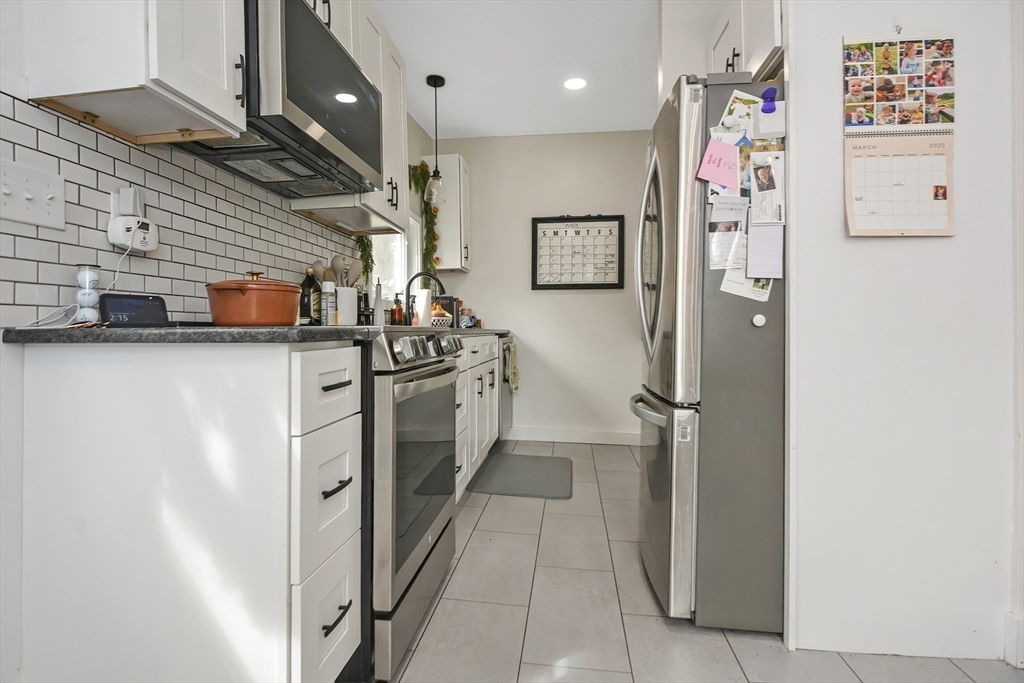 21 Cemetery Street, Unit 21 Hopedale, MA 01747 - Photo 4 of 19 a kitchen with stainless steel appliances a refrigerator and a stove