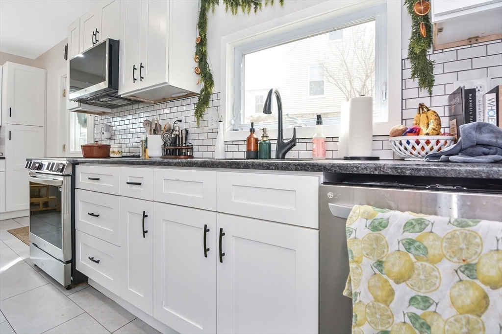 21 Cemetery Street, Unit 21 Hopedale, MA 01747 - Photo 5 of 19 a kitchen with stainless steel appliances granite countertop a stove a sink and a microwave
