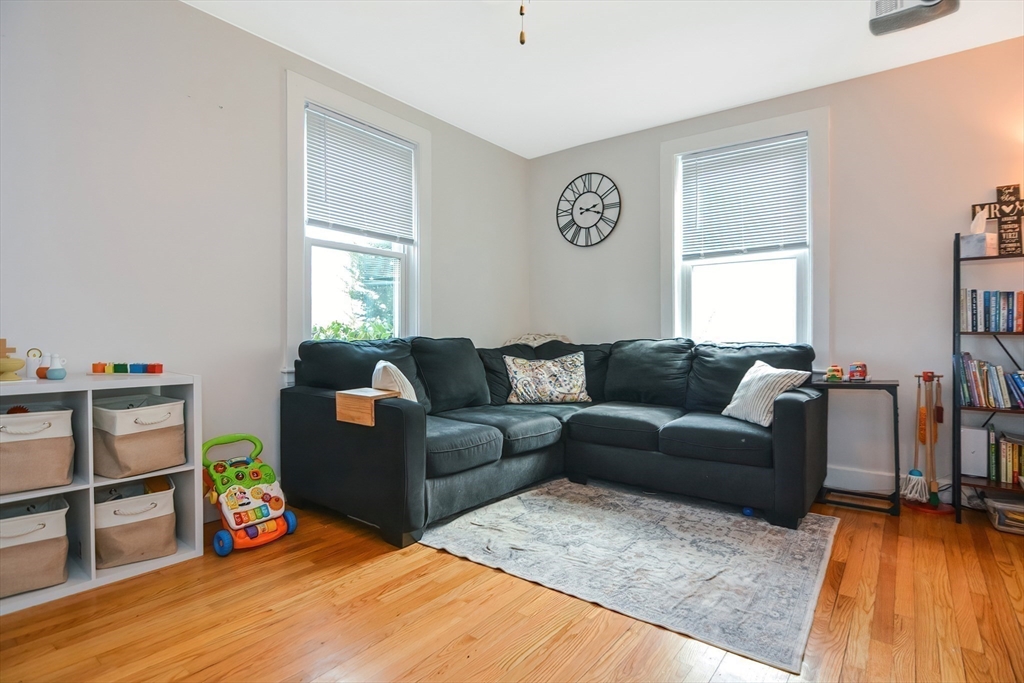 21 Cemetery Street, Unit 21 Hopedale, MA 01747 - Photo 7 of 19 a living room with furniture and a wooden floor