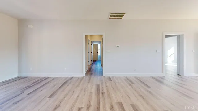 a view of a room with wooden floor