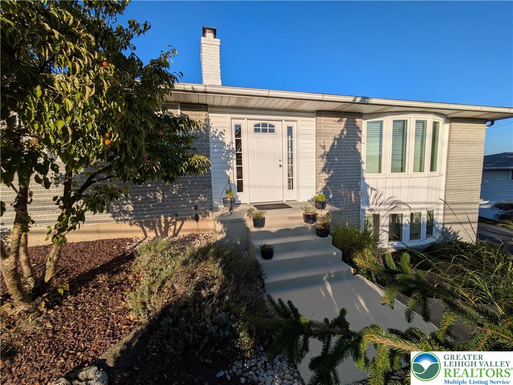 3285 Cherryville Road Northampton, PA 18067 - Photo 4 of 51 Concrete steps lead to a classic entryway flanked by distinctive curved bay windows.