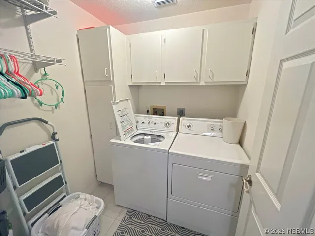 an aerial view of a house with swimming pool and outdoor seating
