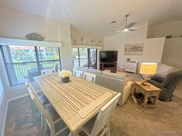 a dining room with furniture and window