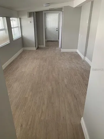 a view of an empty room and a window