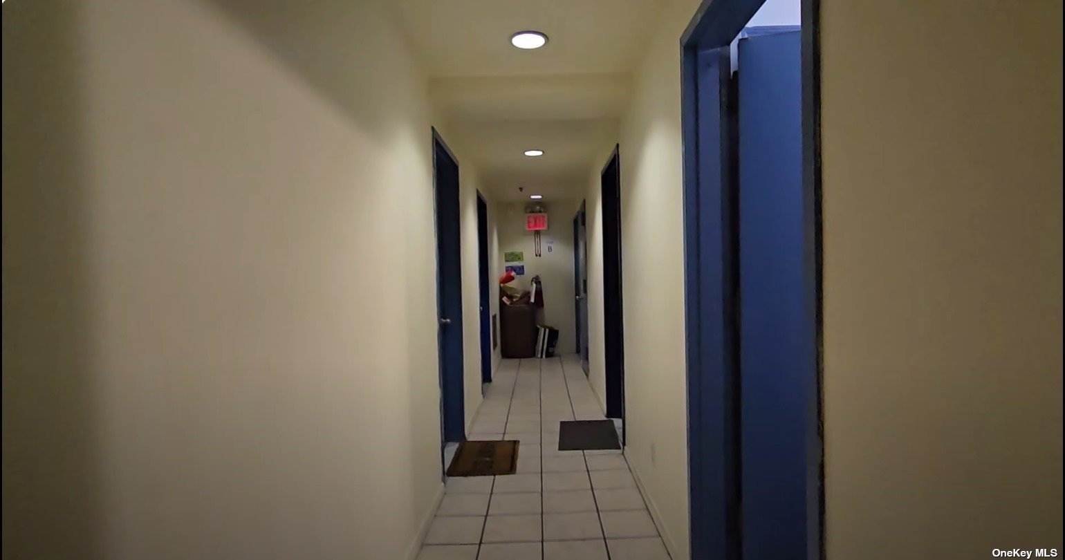 83-17 Broadway Queens, NY 11373 - Photo 16 of 27 a view of a hallway with wooden shelves