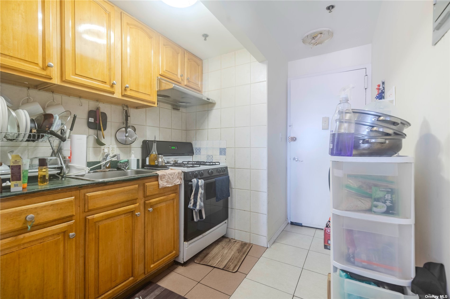 83-17 Broadway Queens, NY 11373 - Photo 17 of 27 a kitchen with stainless steel appliances granite countertop a sink and cabinets