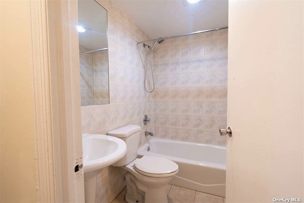 83-17 Broadway Queens, NY 11373 - Photo 19 of 27 a bathroom with a sink toilet and shower