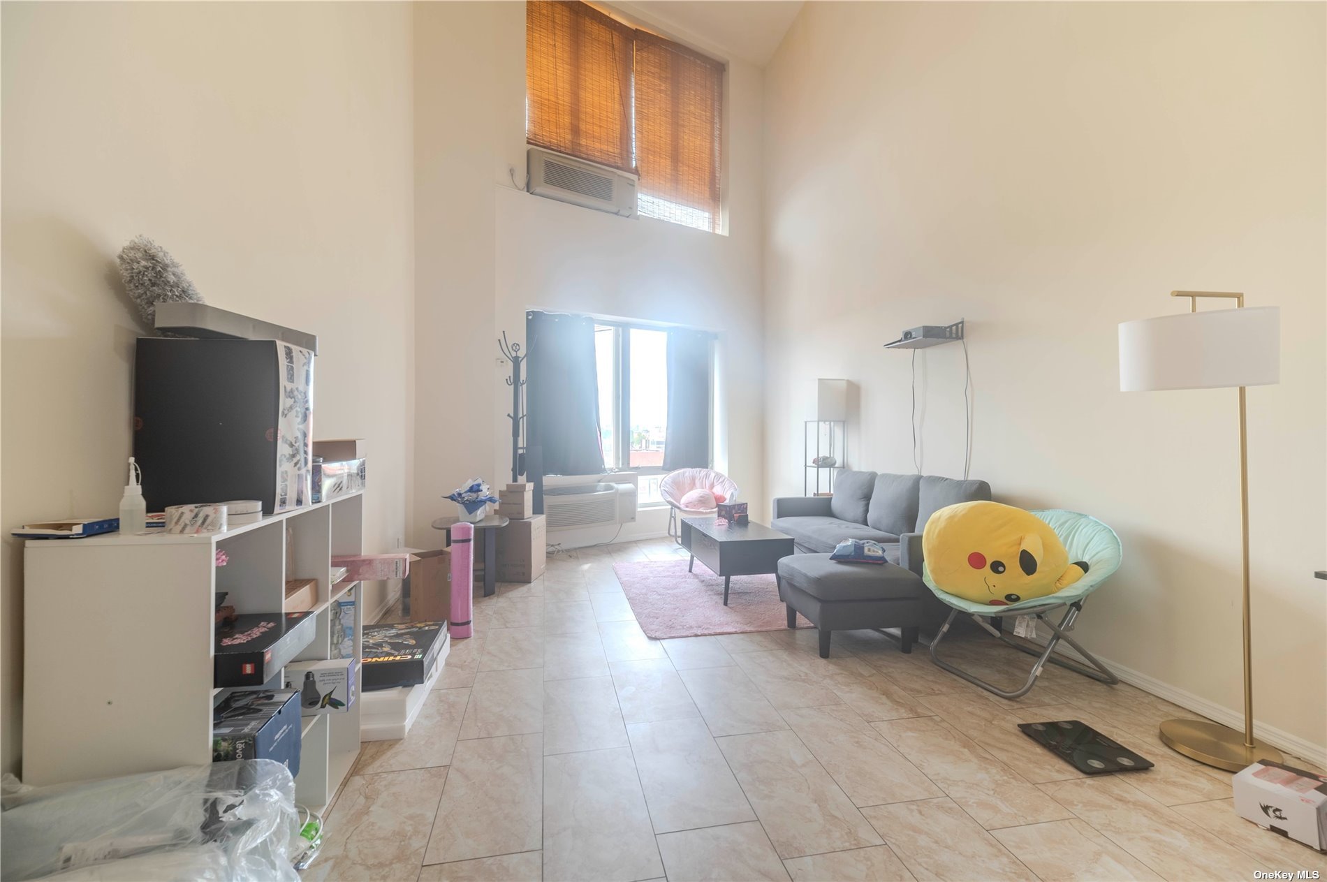 83-17 Broadway Queens, NY 11373 - Photo 22 of 27 a living room with furniture and a flat screen tv