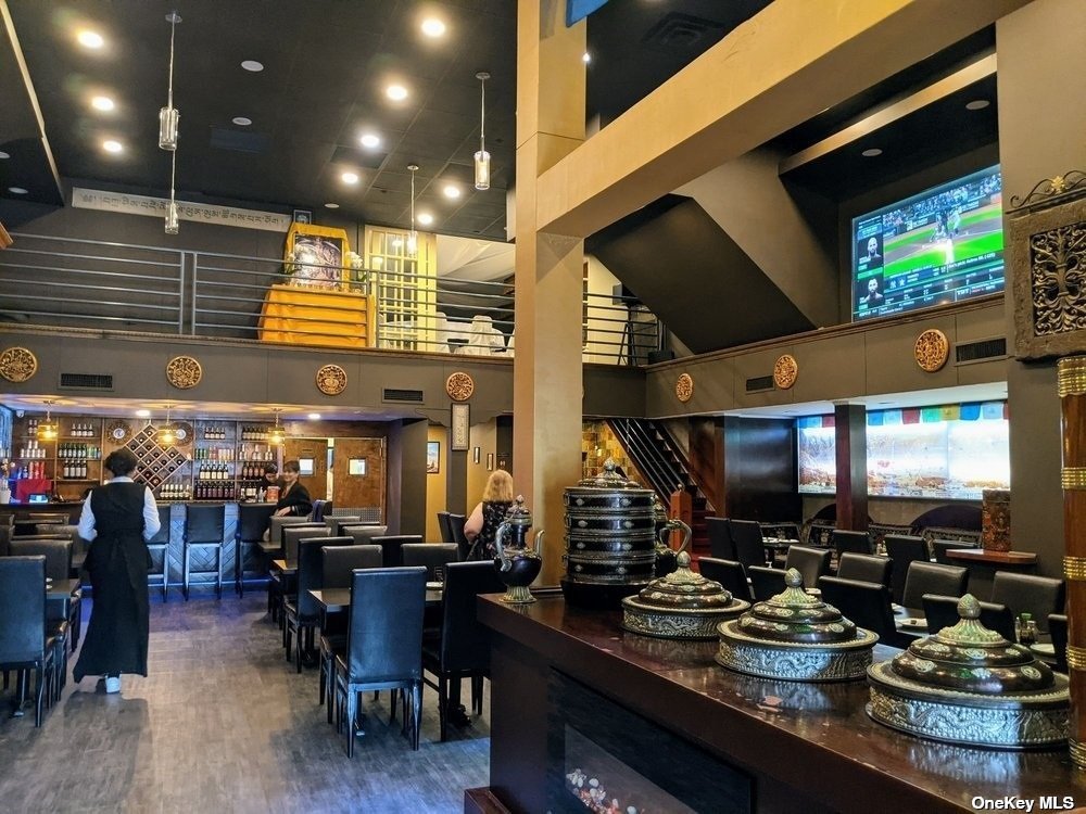 83-17 Broadway Queens, NY 11373 - Photo 7 of 27 a room with lots of chairs and mirrors