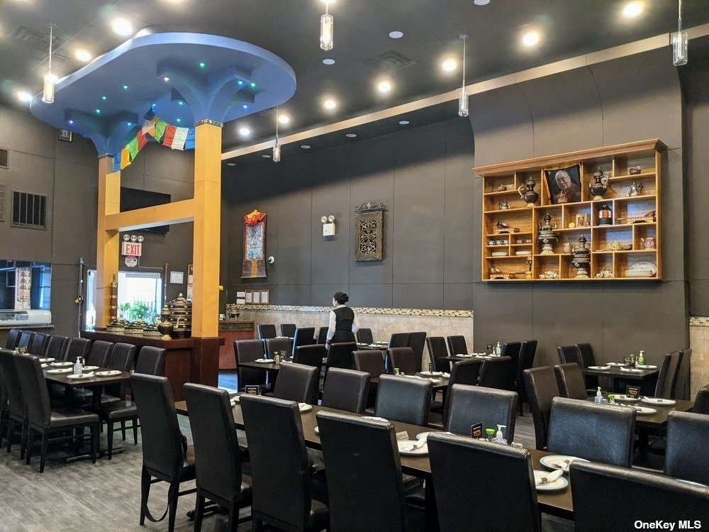 83-17 Broadway Queens, NY 11373 - Photo 8 of 27 a media room with lots of chairs and a projector screen