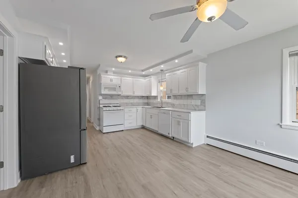 a kitchen with a refrigerator a sink and cabinets
