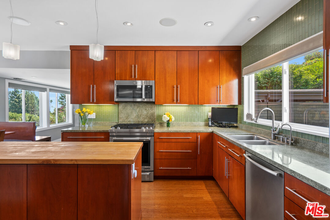 2137 Banyan Drive Los Angeles, CA 90049 - Photo 14 of 39 a kitchen with stainless steel appliances granite countertop sink stove and microwave
