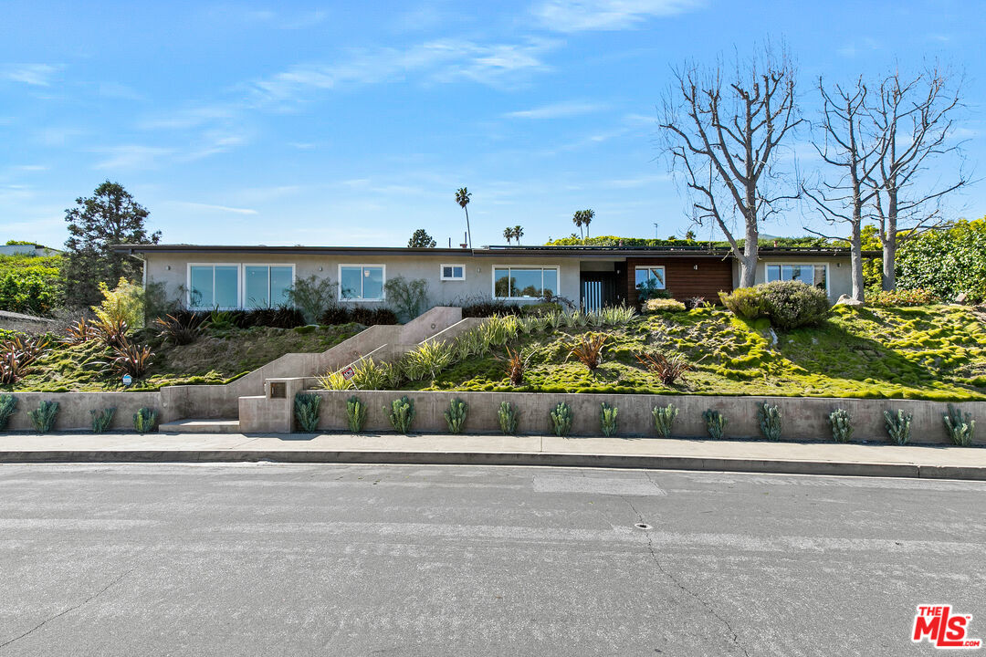 2137 Banyan Drive Los Angeles, CA 90049 - Photo 2 of 39 a front view of a house with a yard