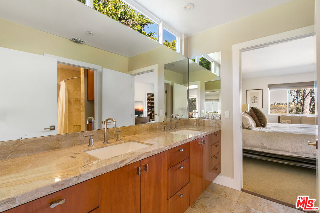 2137 Banyan Drive Los Angeles, CA 90049 - Photo 22 of 39 a spacious bathroom with a granite countertop sink and a mirror